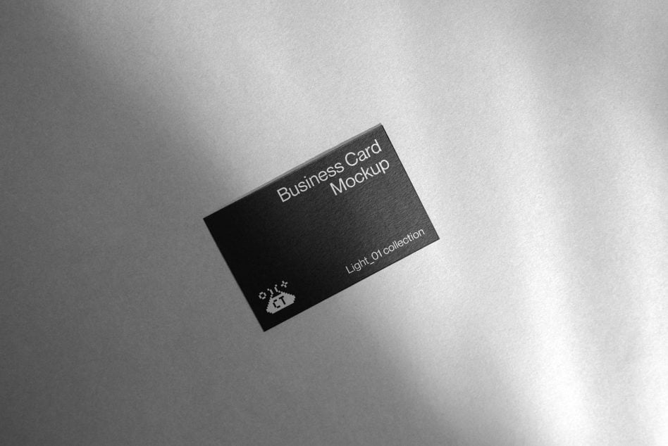 Black business card mockup on light gray textured surface